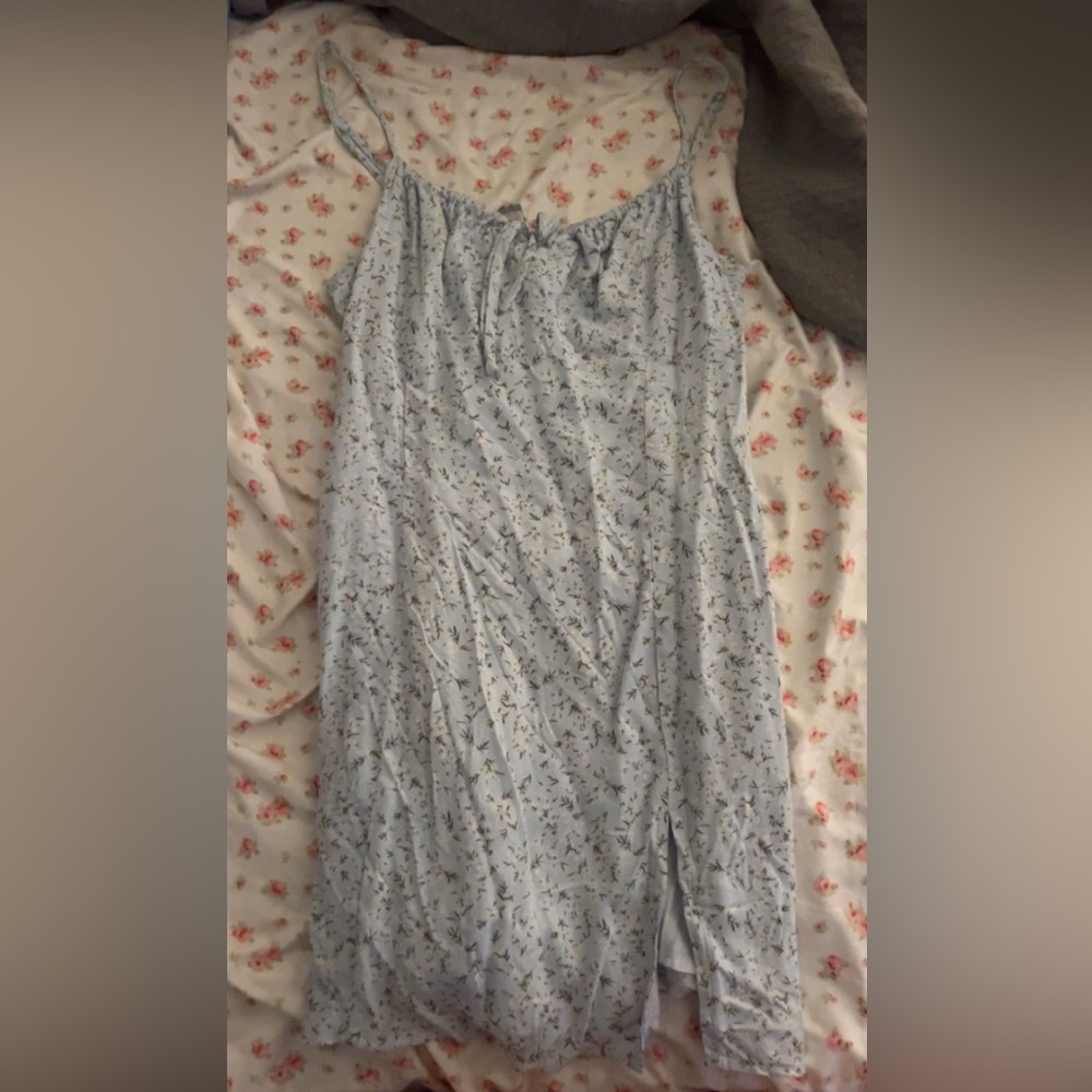 A very cute short dress with a slit that has no damage to it.